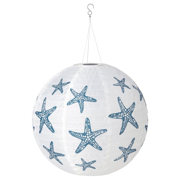 A SOLVINDEN white paper lantern with blue starfish prints, powered by solar energy. Its spherical and hangs from a hook, made from recycled materials.