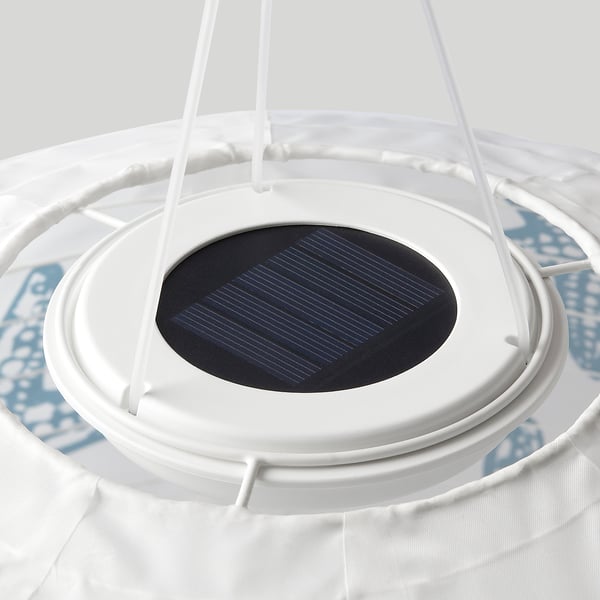 Solar-powered circular lamp with white frame, dark solar panel.