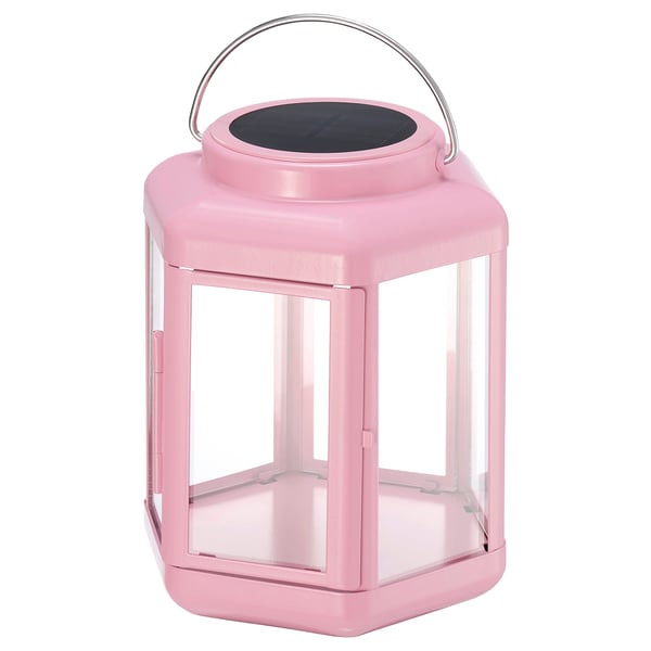 Pink solar-powered lantern with clear glass panels and metal handle. Modern design for indoor/outdoor use.