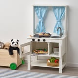 Play kitchen with sink, stove, and pretend food. Curtains can close for role-playing.