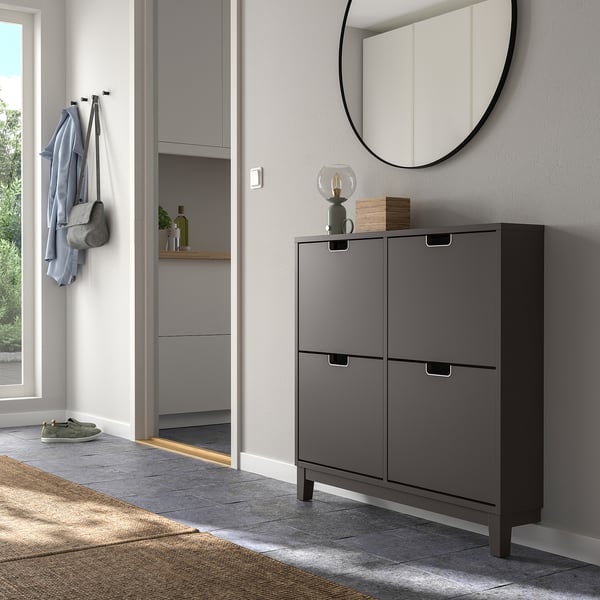 Gray shoe cabinet with 4 compartments near entryway, mirror, and jacket hooks.