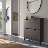 Gray shoe cabinet with 4 compartments near entryway, mirror, and jacket hooks.
