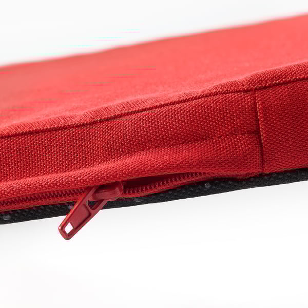 Red chair cushion with smooth, durable fabric and sturdy zipper.