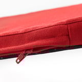 Red chair cushion with smooth, durable fabric and sturdy zipper.