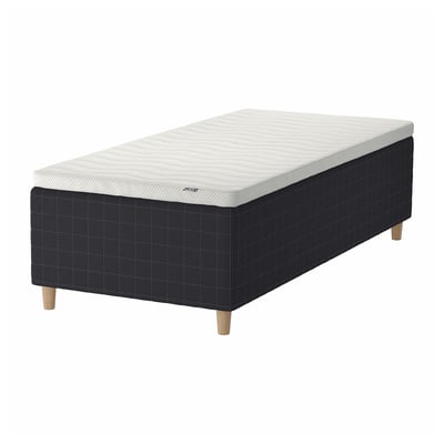 Black-and-white STAVANGER bed with wooden base, sprung mattress, and dark checkered design.
