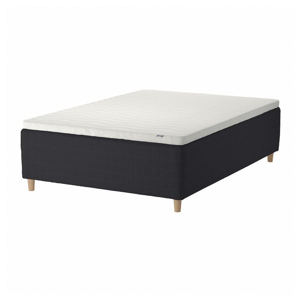 Black and white square-patterned bed with wooden legs.