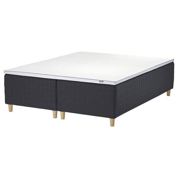 Black IKEA STAVANGER bed with memory foam mattress and wooden base.