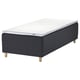 An IKEA STAVANGER bed in dark grey with a white mattress. It wooden legs and a quilted design.