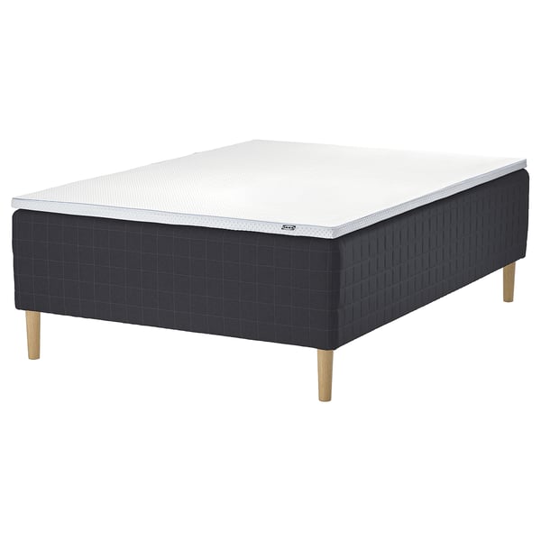 The STAVANGER mattress set in dark grey with wooden legs. It combines supportive springs and a cooling memory foam top for comfort.