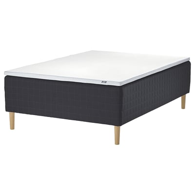 The STAVANGER mattress set in dark grey with wooden legs. It combines supportive springs and a cooling memory foam top for comfort.
