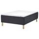 A STAVANGER bed with a dark grey quilted base and light grey mattress on wooden legs.