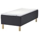 Black ikea STAVANGER bed with dark grey quilted frame and light wooden legs. Mattress has white and grey textured surface for comfort and support.