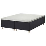 A STAVANGER bed in black with light grey mattress. It has wooden legs and a grid pattern.