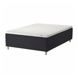A black ikea STAVANGER bed with a white mattress featuring wood legs, designed for comfort and airflow.