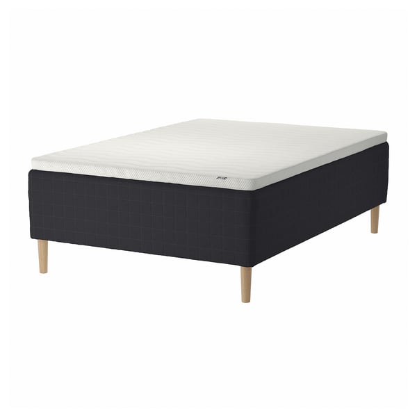 A black and white STAVANGER mattress set with wooden legs. It a quilted top and a sprung base for comfort and air flow.