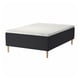 A black and white STAVANGER mattress set with wooden legs. It a quilted top and a sprung base for comfort and air flow.