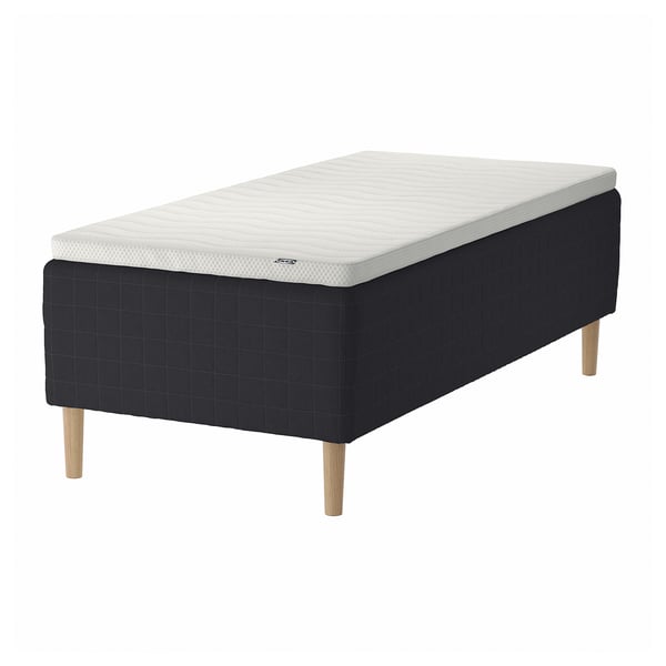 New STAVANGER bed in black with white mattress, square tufted design, wooden legs.