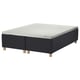 An STAVANGER bed base in black with a white mattress sat on four wooden legs, offering a sleek and supportive look.