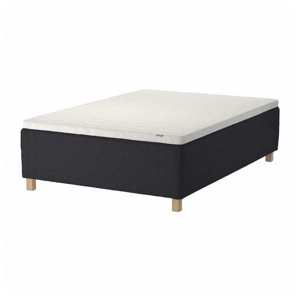 A black STAVANGER bed with a white mattress, featuring wooden legs and a quilted design.
