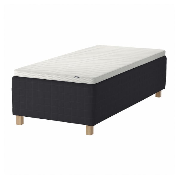A black STAVANGER bed with light gray mattress, featuring wooden legs.