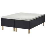 Modern black bed with gray memory foam mattress, featuring wooden legs, designed for comfort and support.