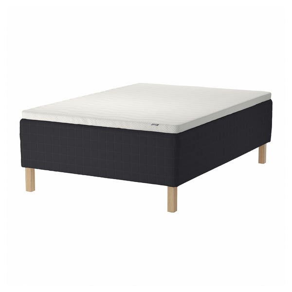 Black & white STAVANGER bed with wooden legs, quilted pattern, white background.