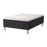 Black & white STAVANGER bed with wooden legs, quilted pattern, white background.