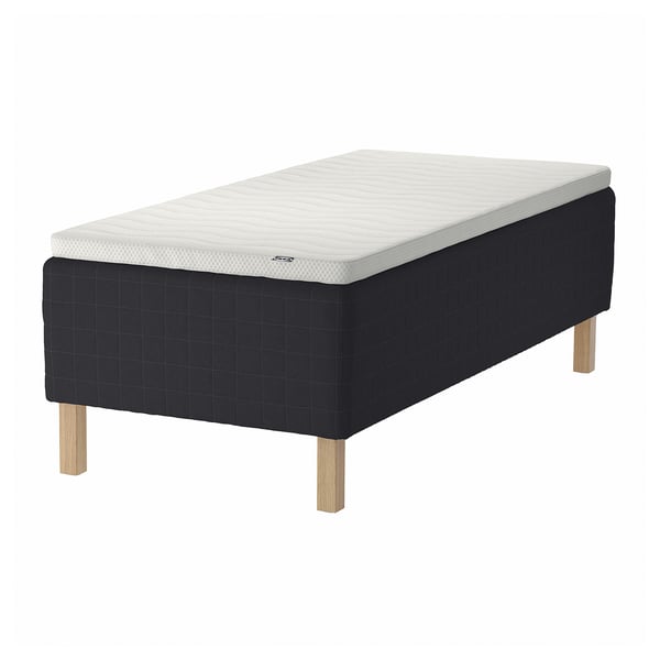 A black STAVANGER wooden bed base with a white mattress on a white background.