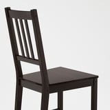 Dark wooden chair with vertical slatted back and square seat, showcasing sturdy craftsmanship.