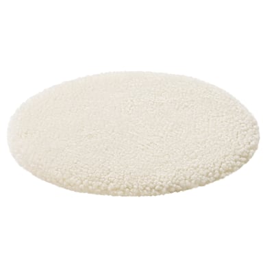 Circular white sheepskin rug, plush and soft.