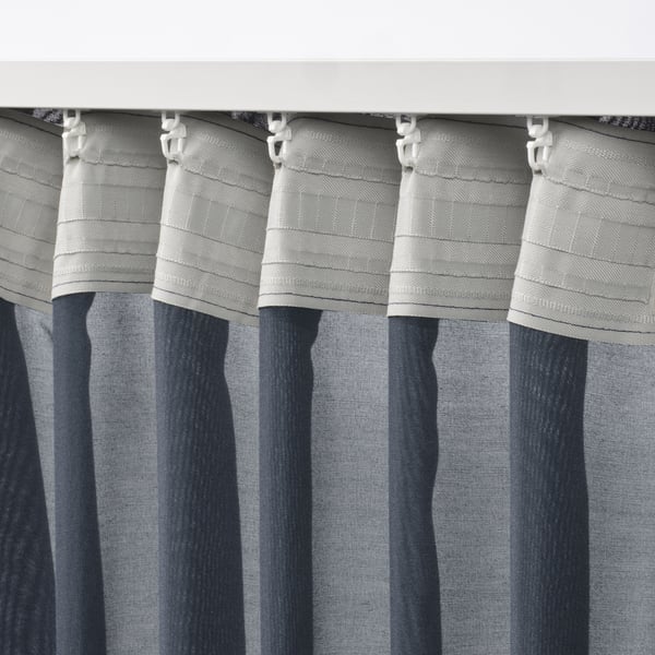 Curtains with white hooks, pleated, and striped blue-gray.