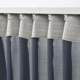 Curtains with white hooks, pleated, and striped blue-gray.