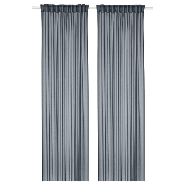 Two dark blue STENFRÖ sheer curtains hang straight, featuring heading tape, offering a soothing, relaxed vibe.