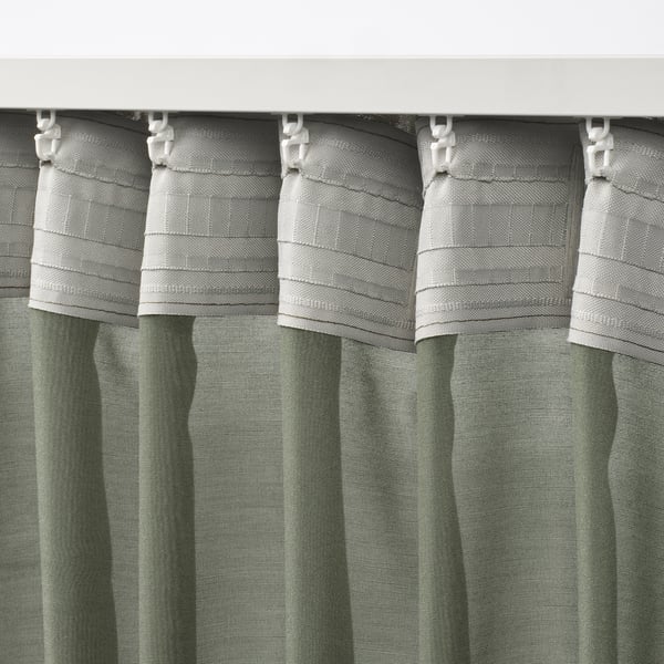 Close-up of gray STENFRÖ curtains with white hooks and heading tape, showcasing pleated design for easy hanging and light diffusion.