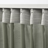 Close-up of gray STENFRÖ curtains with white hooks and heading tape, showcasing pleated design for easy hanging and light diffusion.