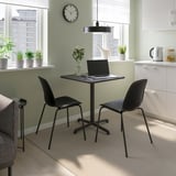 Black STENSELE dining set with small table and chairs. Fits laptop, vase, and saves space.
