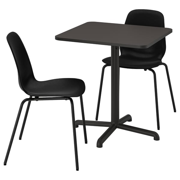 The STENSELE set in black. It includes a small square table with sleek, metal legs and two matching black chairs with curved backs and seats.