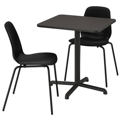 The STENSELE set in black. It includes a small square table with sleek, metal legs and two matching black chairs with curved backs and seats.