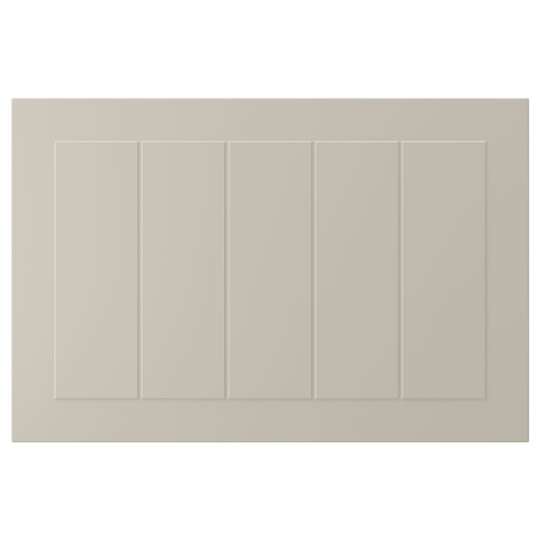 A beige STENSUND cabinet door with a rectangular shape and grooved panel design, made of fiberboard.