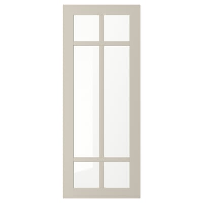 A beige STENSUND glass door with a simple frame and divided glass panel, offering a stylish and warm display.