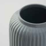 Gray vase with vertical grooves.