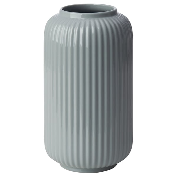 A tall, light blue, ribbed vase made of stoneware. Its design vertical grooves and a smooth, wide opening at the top.