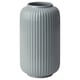 Option: A tall, light blue, ribbed vase made of stoneware. Its design vertical grooves and a smooth, wide opening at the top.