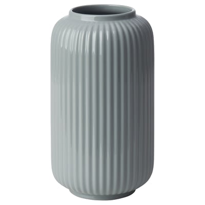 A tall, light blue, ribbed vase made of stoneware. Its design vertical grooves and a smooth, wide opening at the top.