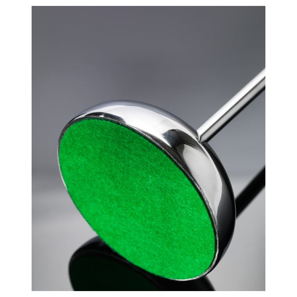 A sleek stainless-steel candlestick with green felt base for stability and protection.