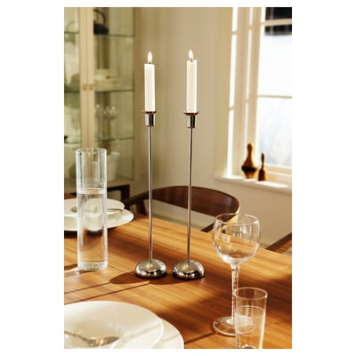 Elegant STOCKHOLM silver candlesticks on wooden table with white plates and wine glasses.