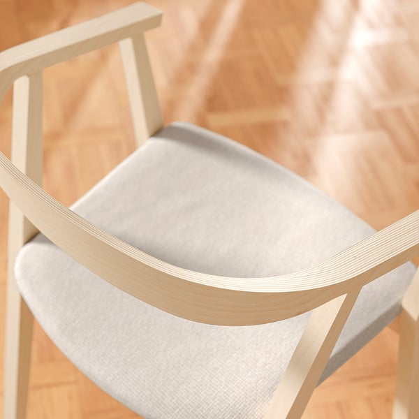 Modern wooden chair with white cushion, showcasing high-quality craftsmanship and durability.