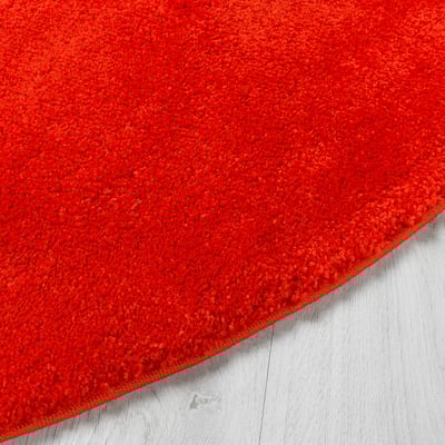 Bright orange rug with soft, thick pile; durable and stain-resistant. Perfect for cozy, sound-dampened floors. Part of the nytillverkad collection.