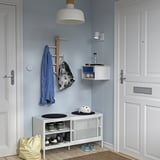 A compact, minimalist white hallway setup with STOMSÖ; small, modern storage, hanging hooks, and wall-mounted shelves.