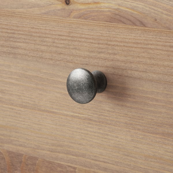 Close-up of wooden drawer handle with sturdy, dark finish and visible wood grain.